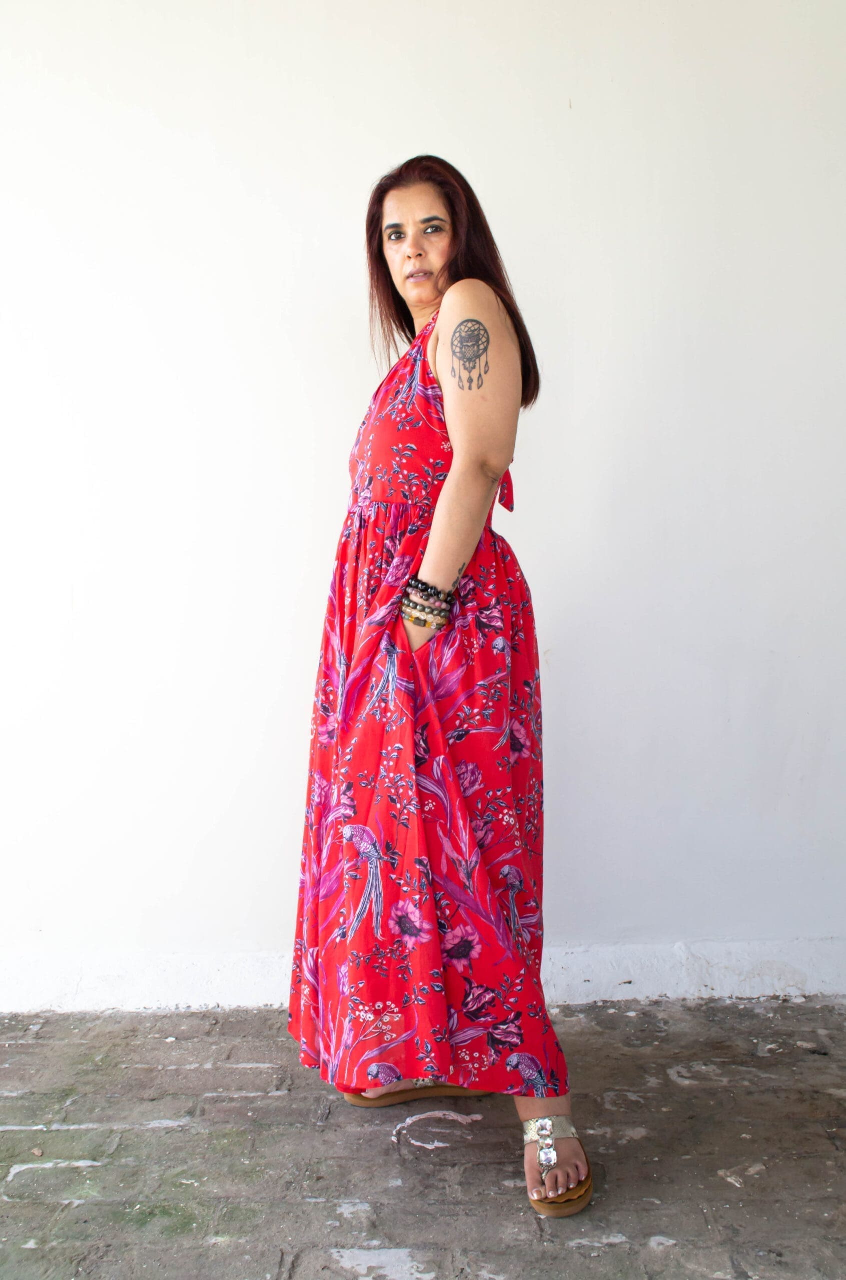 Model in Red Printed Backless Halter Dress posing side